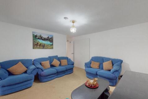 A bright and welcoming living room featuring tw...