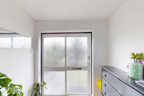 Bright and clean bedroom with a large window al...