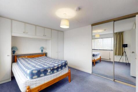 A well-lit double bedroom featuring a double be...