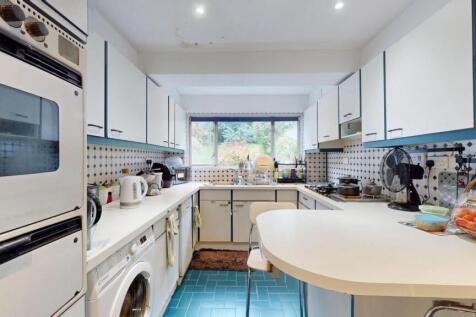 Bright and modern kitchen featuring ample natur...