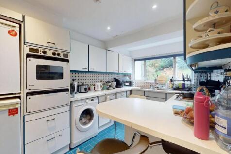 A bright and well-organized kitchen with ample ...