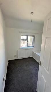 A cozy, well-maintained bedroom featuring a win...