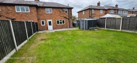 A well-maintained, spacious garden area surroun...