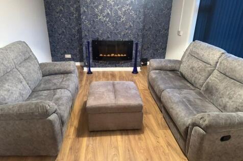 Modern and spacious living room featuring two c...