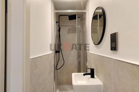 Bright and modern bathroom featuring a compact ...