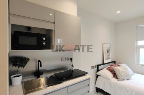 A modern, well-maintained studio with a compact...
