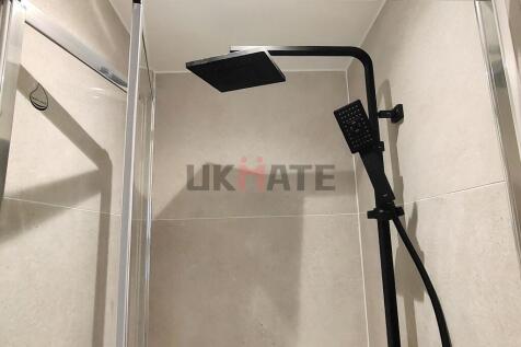Modern bathroom featuring a sleek black shower ...