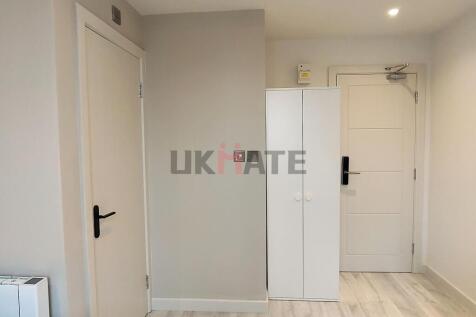 Bright and well-maintained hallway with white d...
