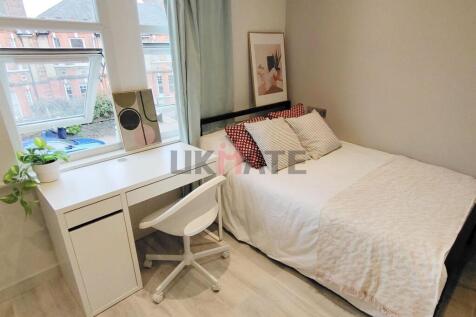 A bright, neatly organized bedroom featuring a ...