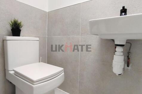 A clean and modern bathroom with a white toilet...