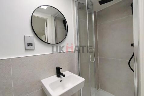 A modern bathroom featuring a small sink with a...