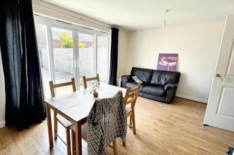 A bright and inviting living room featuring a w...