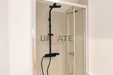Modern bathroom with a large shower cubicle fea...