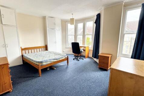 Bright and spacious living room featuring large...