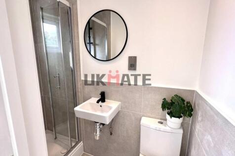 Modern bathroom with a compact shower cubicle, ...