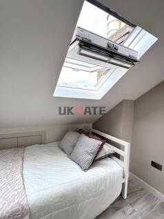 A cozy double bedroom featuring a clean, neatly...