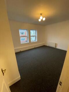 A spacious living room featuring large windows ...