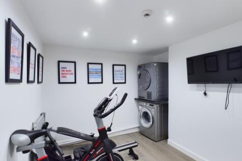 A bright and clean gym area with modern equipme...