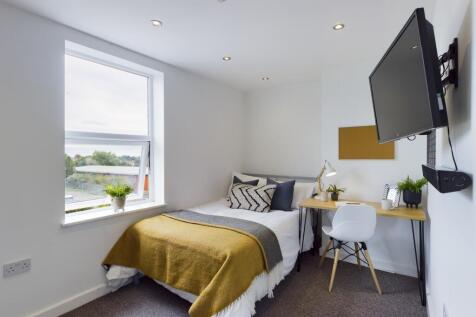 A bright and tidy double bedroom featuring mode...