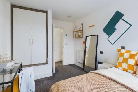 A bright and inviting double bedroom featuring ...