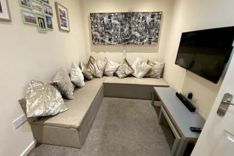 A cozy living room with comfortable seating, pe...