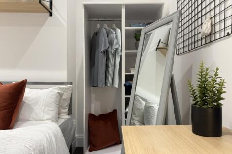 A stylish and inviting double bedroom with ampl...