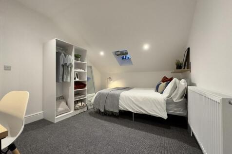 A bright and tidy double bedroom featuring a st...