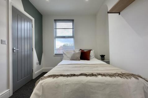 A bright and inviting double bedroom with moder...