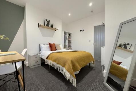 A stylish and spacious double bedroom featuring...