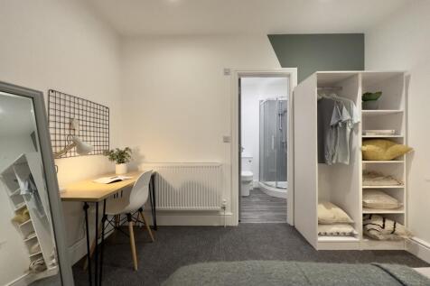 A bright and spacious double bedroom featuring ...