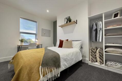 A bright and inviting double bedroom featuring ...