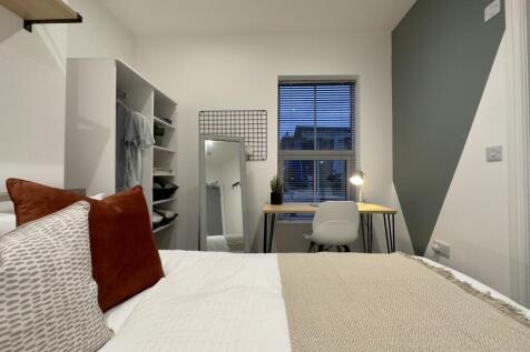 A bright and inviting double bedroom with moder...