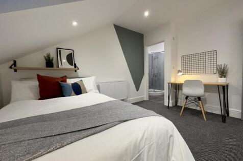 A spacious and well-lit large double bedroom wi...