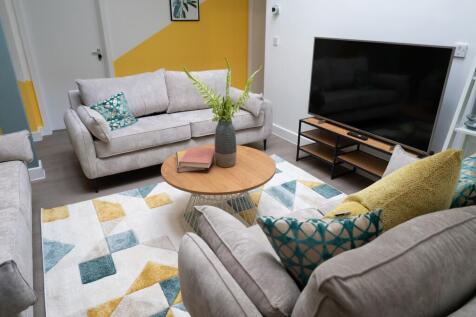 A spacious and inviting modern living room, per...