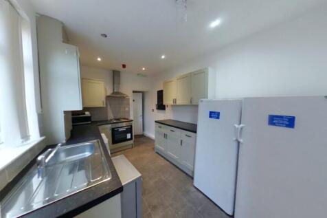 A spacious and modern kitchen featuring ample c...