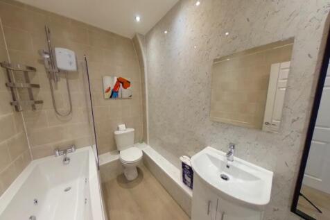 A spacious and immaculate bathroom featuring a ...