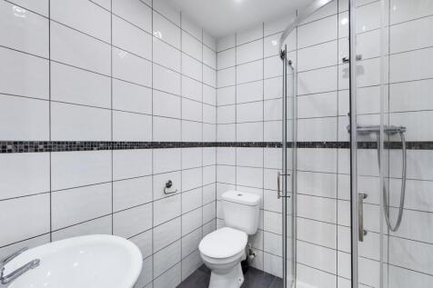 A modern and immaculate bathroom featuring a sl...