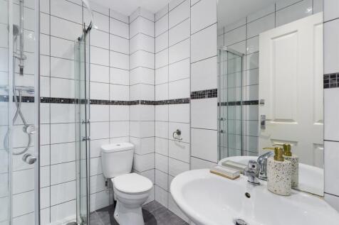 A modern and pristine bathroom featuring a styl...