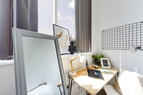 A bright and inviting communal workspace featur...