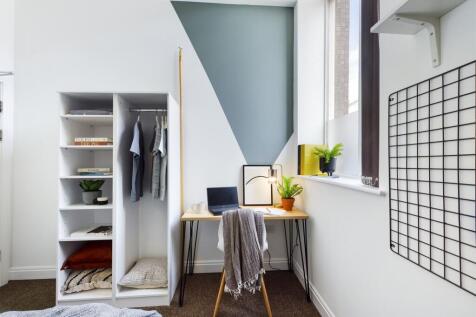 A bright and stylish double bedroom featuring a...