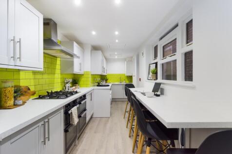 A modern and spacious kitchen with bright color...