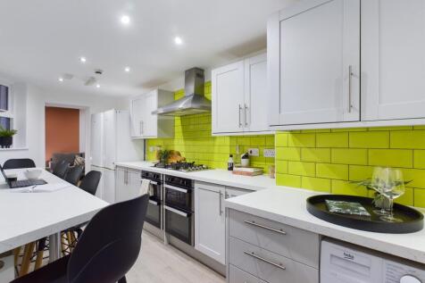 A stylish and modern kitchen featuring vibrant ...