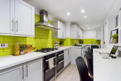 A modern and bright kitchenette featuring vibra...