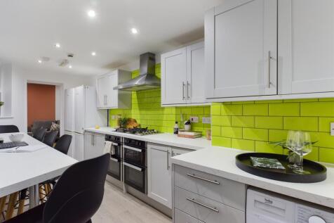 A modern and spacious kitchen featuring vibrant...
