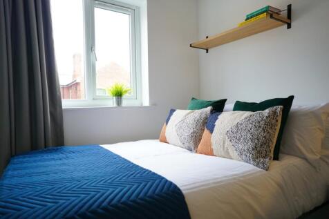 A bright and inviting double bedroom featuring ...