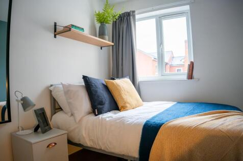 A stylish and inviting double bedroom with ampl...