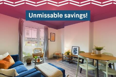 A bright and welcoming living room featuring co...