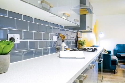 Bright and modern kitchen with sleek white coun...