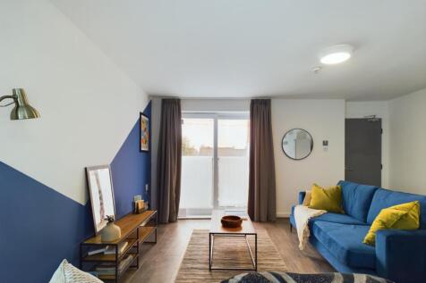 A bright and inviting living room featuring com...