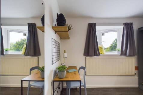 A bright and modern living room featuring two l...